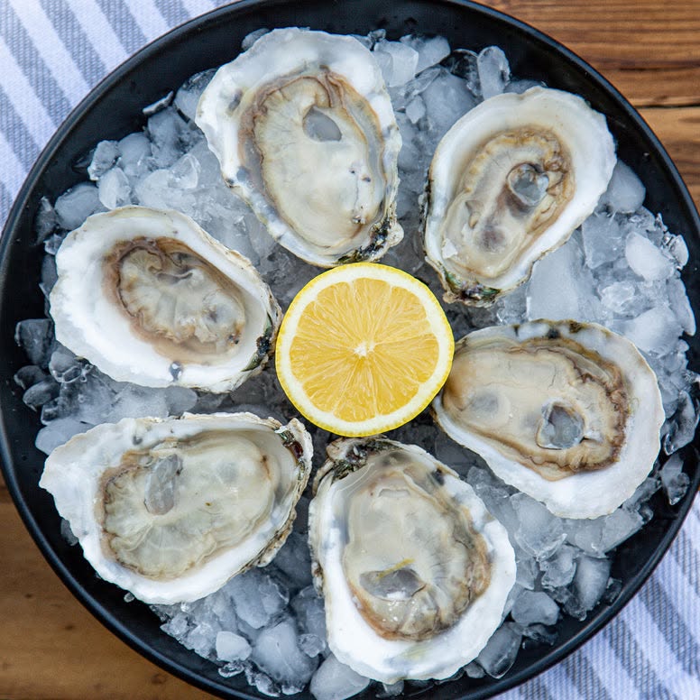 Half-dozen fresh-shucked oysters on crushed ice with lemon, served at a Kraken Oyster Co. pop-up